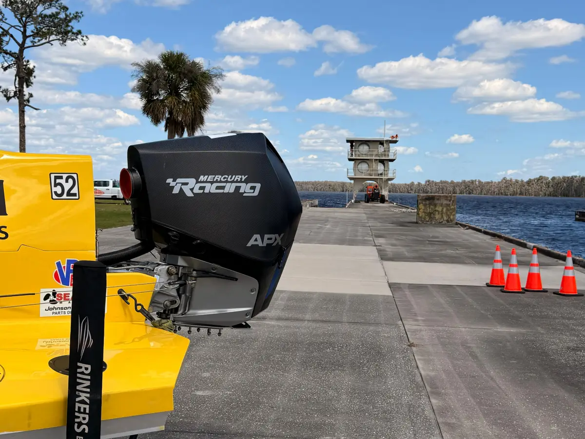 Mercury Racing APX engine on Rinker Racing number 52 at Lake X, with the iconic observation tower in the background