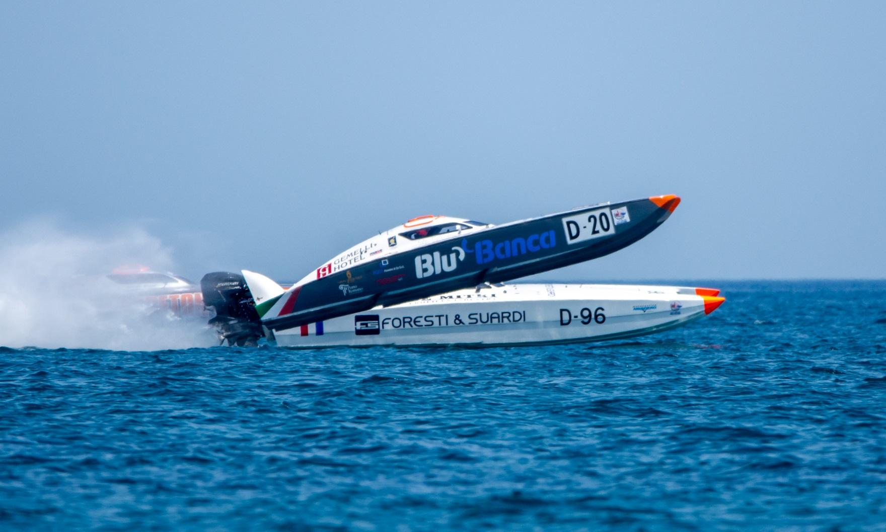 Offshore category gold: two Class 3D offshore powerboats at speed on blue water at Trani, Italy