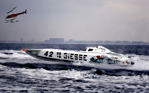 Giesse Philosophy Class 1 catamaran number 42 racing at speed with helicopter overhead, 1994 World Championship