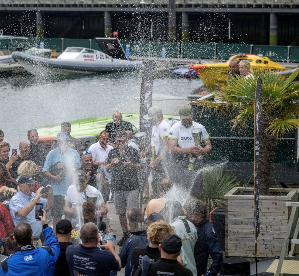 Mike Howe, Tim Linden and Scott Younger celebrate winning the UKOPRA Solent 80 with champagne at Haslar Marina, 2024