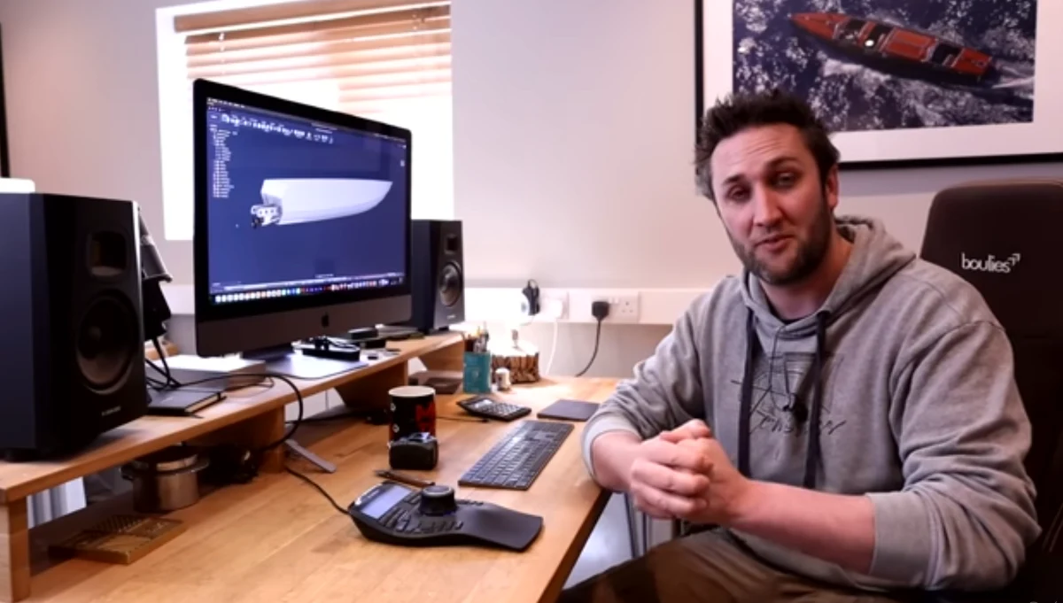 Dan Lee at his desk with the 3D CAD model of Apache 555 displayed on screen during hull analysis