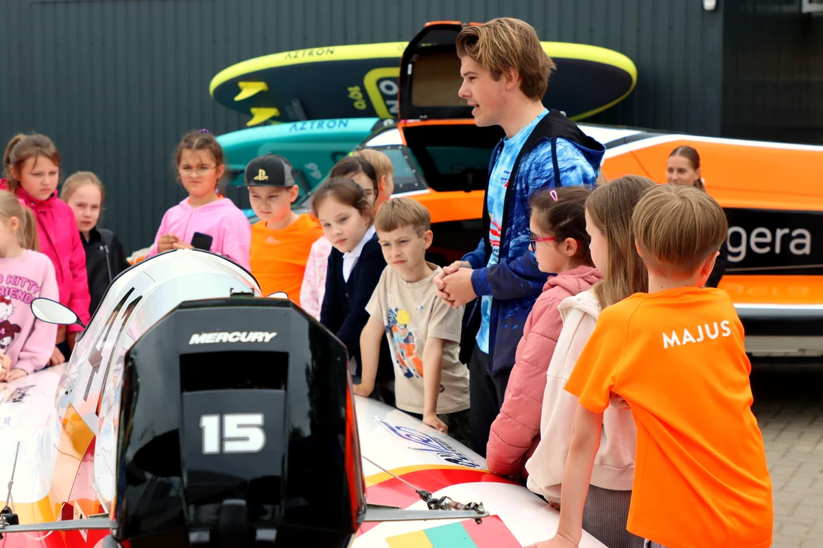Young pilots inspect a Formula Future boat at the Lithuanian Motorboat Academy, Kaunas
