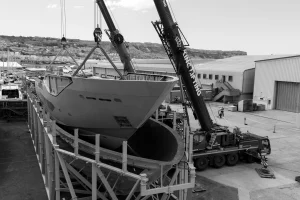 Sunseeker 134 Superyacht hull being lifted by twin cranes at Osprey Quay, Portland