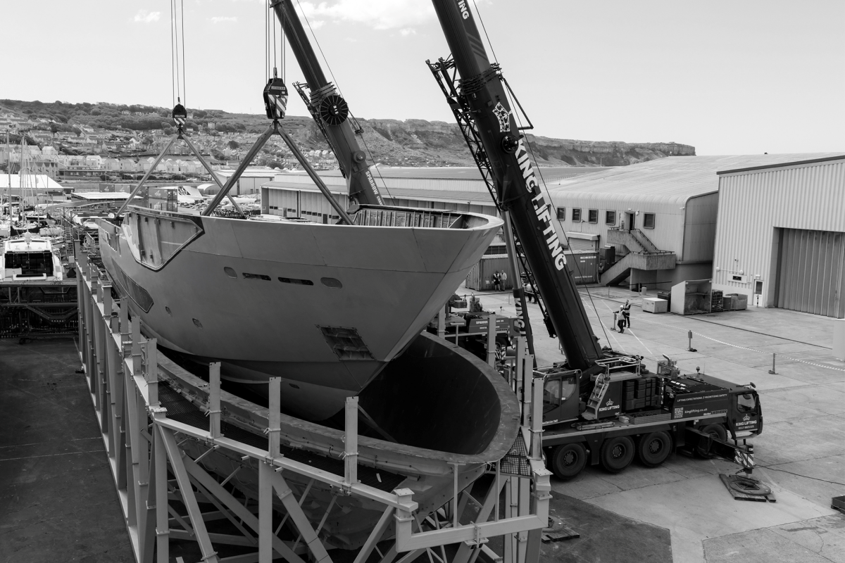 Sunseeker 134 Superyacht hull being lifted by twin cranes at Osprey Quay, Portland