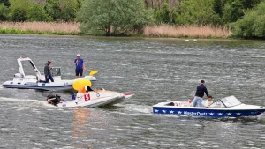 Boat 5 Team Autovision escorted from the circuit by safety boats after retiring in hour seven of Race 1 at the 24 Heures Motonautiques de Normandie 2026, Poses