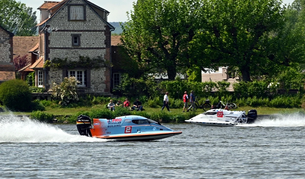 Boat 2 Team Touax MRK Racing leads Boat 1 Team Inshore Performance on the River Seine at Poses during Race 2 of the 24 Heures Motonautiques de Normandie 2026, with spectators watching from the far bank