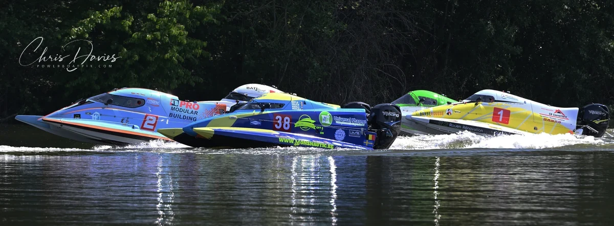 Boats 2 (Team Touax MRK Racing), 38 (Monsnauteam) and 1 (Team Inshore Performance) race three-abreast on the River Seine during Race 1 of the 24 Heures Motonautiques de Normandie 2026, Poses