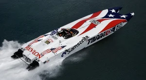 Don Johnson's Team USA catamaran number 50 racing at speed, Samsonite and Revlon sponsorship, 1989