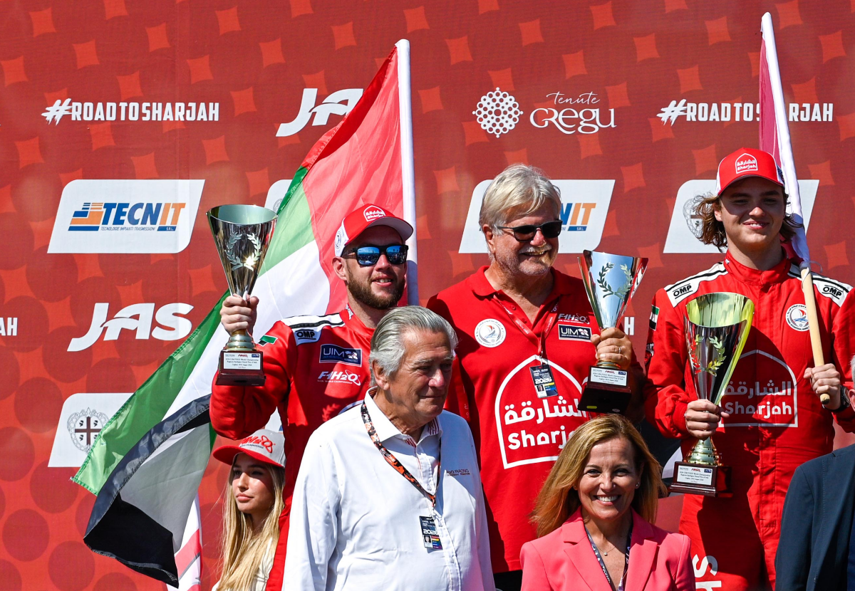 Grant Trask and Stefan Arand on the podium at the Regione Sardegna Grand Prix of Italy 2026 in Cagliari, with Sharjah Team principal Scott Gillman between them