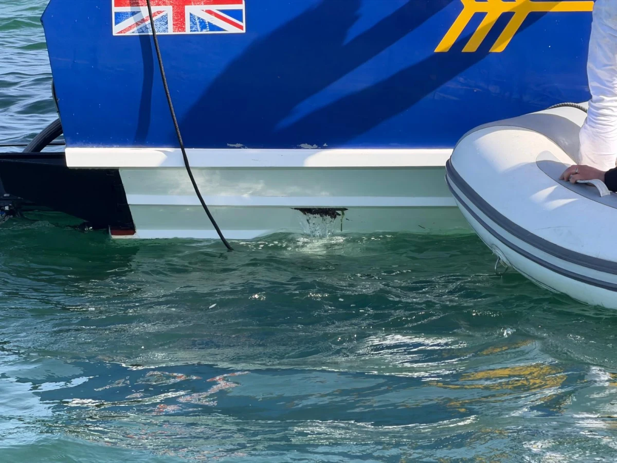 Impact hole in the hull of Apache 555 after striking submerged debris during the 2026 Poole Bay 100