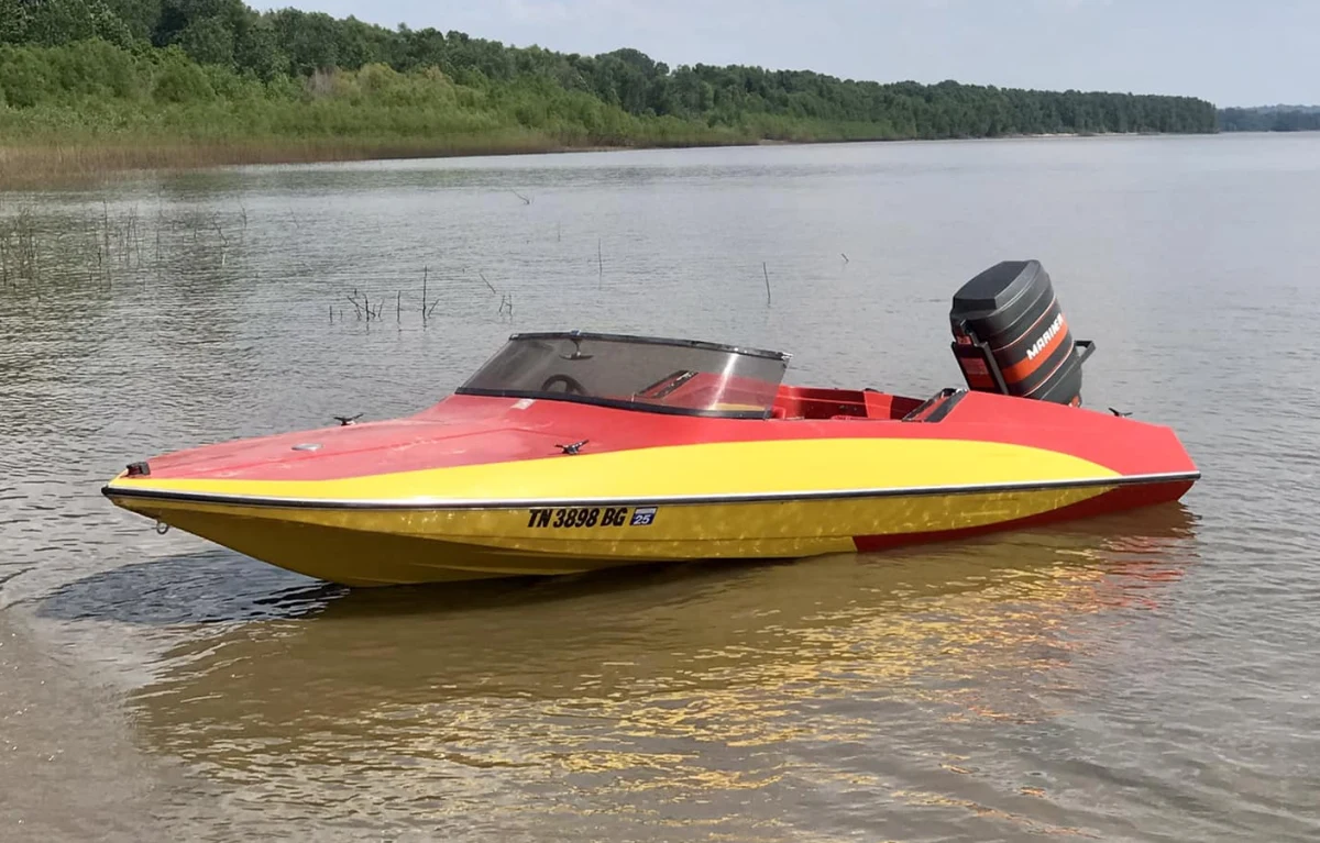 A restored Glastron GT-150 runabout on the water, the model used in the 1973 James Bond film Live and Let Die