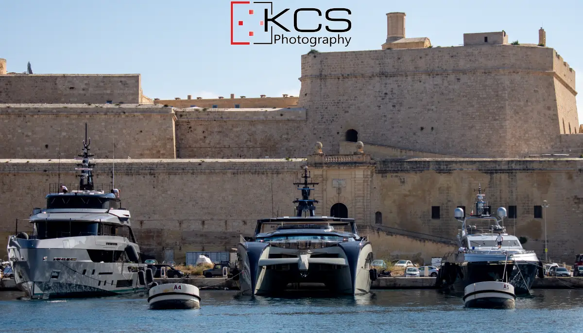 Three Rossinavi superyachts berthed below the stone fortifications on the Vittoriosa side of Malta's Grand Harbour