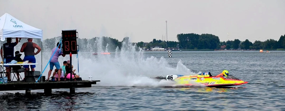 Alessandro Cremona's yellow number 46 F.250 boat throwing spray past the timing platform at Chodziez