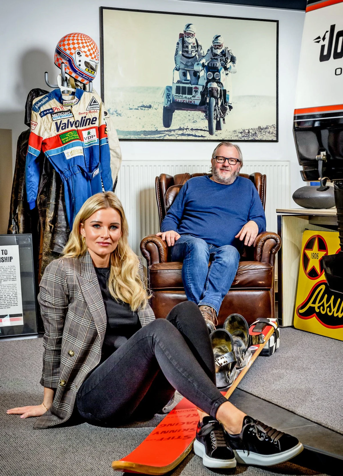 Danny Bertels sits with his daughter Roxanne among his powerboat racing and Paris-Dakar memorabilia