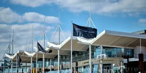 Gunwharf Quays Marina, Portsmouth, with waterfront flags flying outside the outlet centre