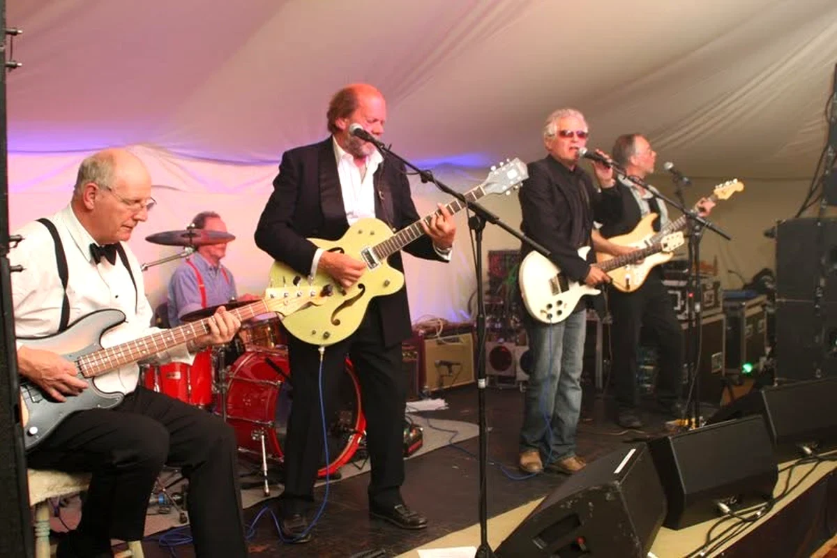 John Caulcutt performing on guitar with his band