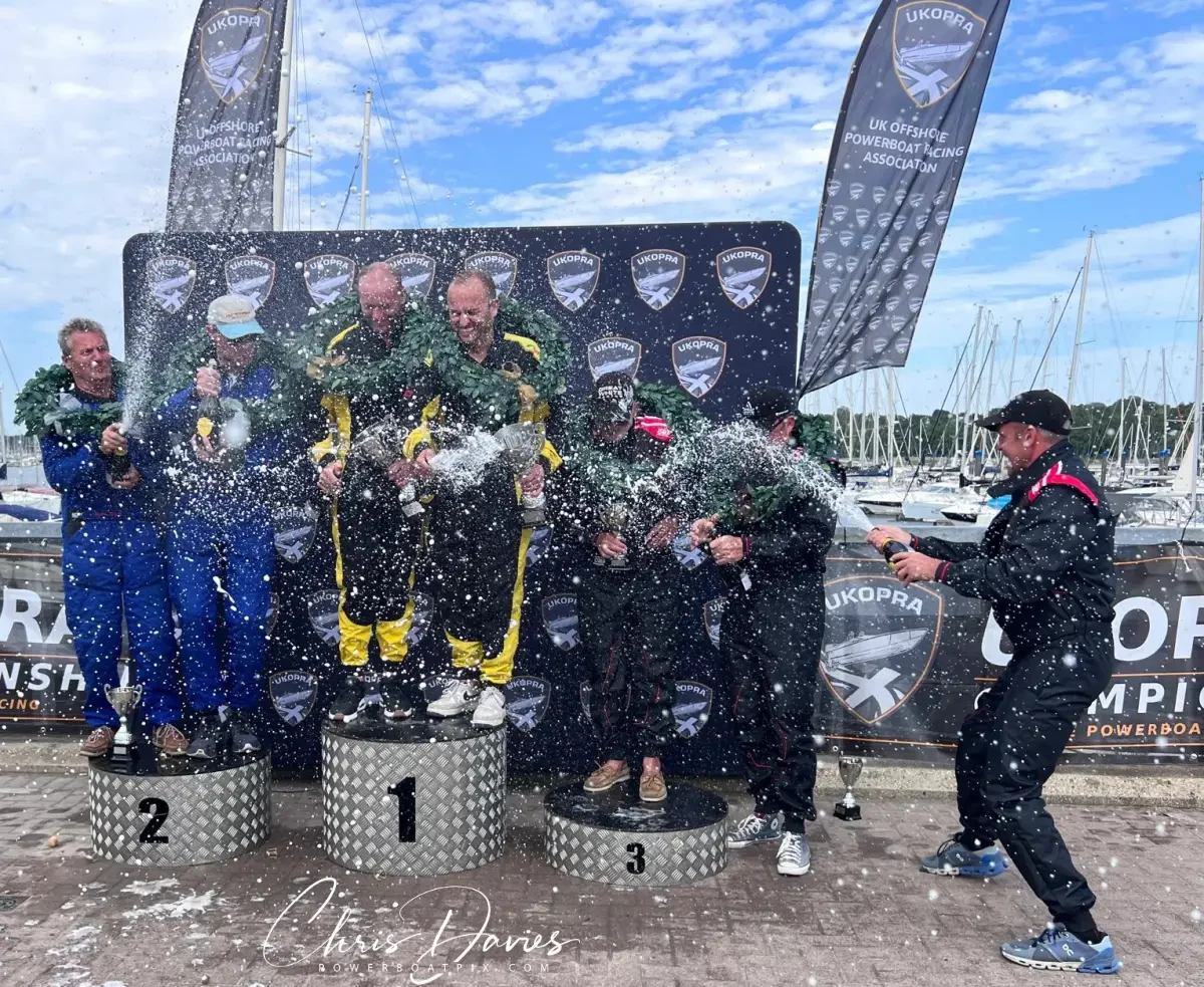 The Class 2 podium at UKOPRA Round 4, the MDL Marinas Mercury Offshore Grand Prix 2026, with Lightning Strikes on the top step spraying champagne