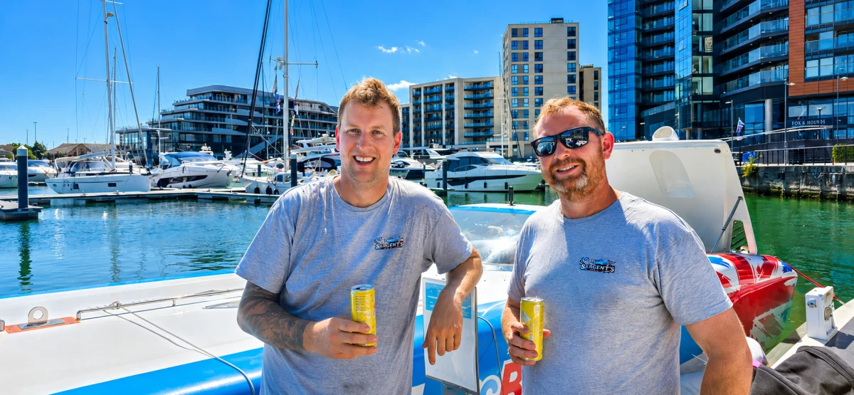 Alex Welham and Neil Raven stand aboard Sixty9 at Ocean Village Marina after winning Class 1L at the MDL Marinas Ocean Village Cup