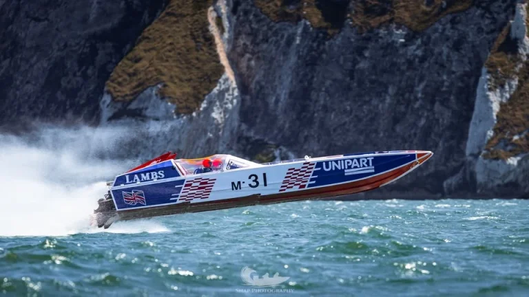 Unipart (M-31) airborne off the Needles during the MDL Marinas Ocean Village Cup