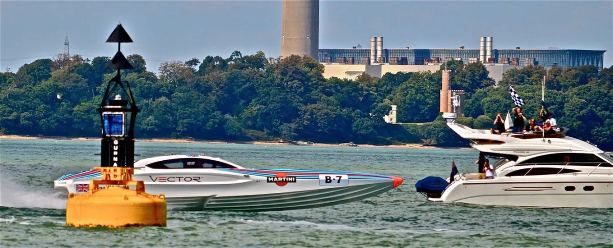 Vector Martini Racing boat racing past a buoy at Cowes 2014