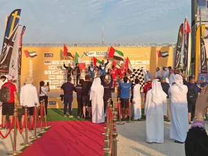 Podium celebrations at the XCAT Dubai Grand Prix with the Burj Khalifa in the background