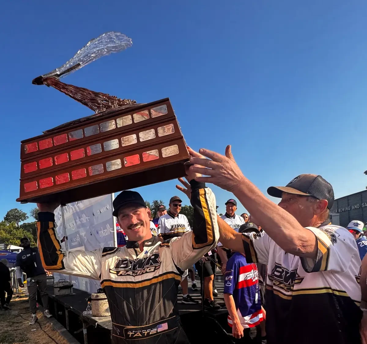 Andrew Tate lifts the Apollo Mechanical Cup trophy with the BWR Racing team at Seafair 2026