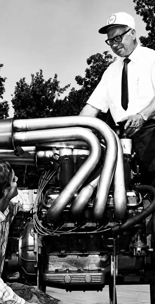 Carl Kiekhaefer examining a large V8 racing engine
