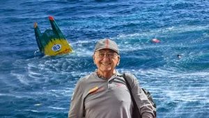 Carlo Borlenghi pictured at a race event with a capsized powerboat behind him