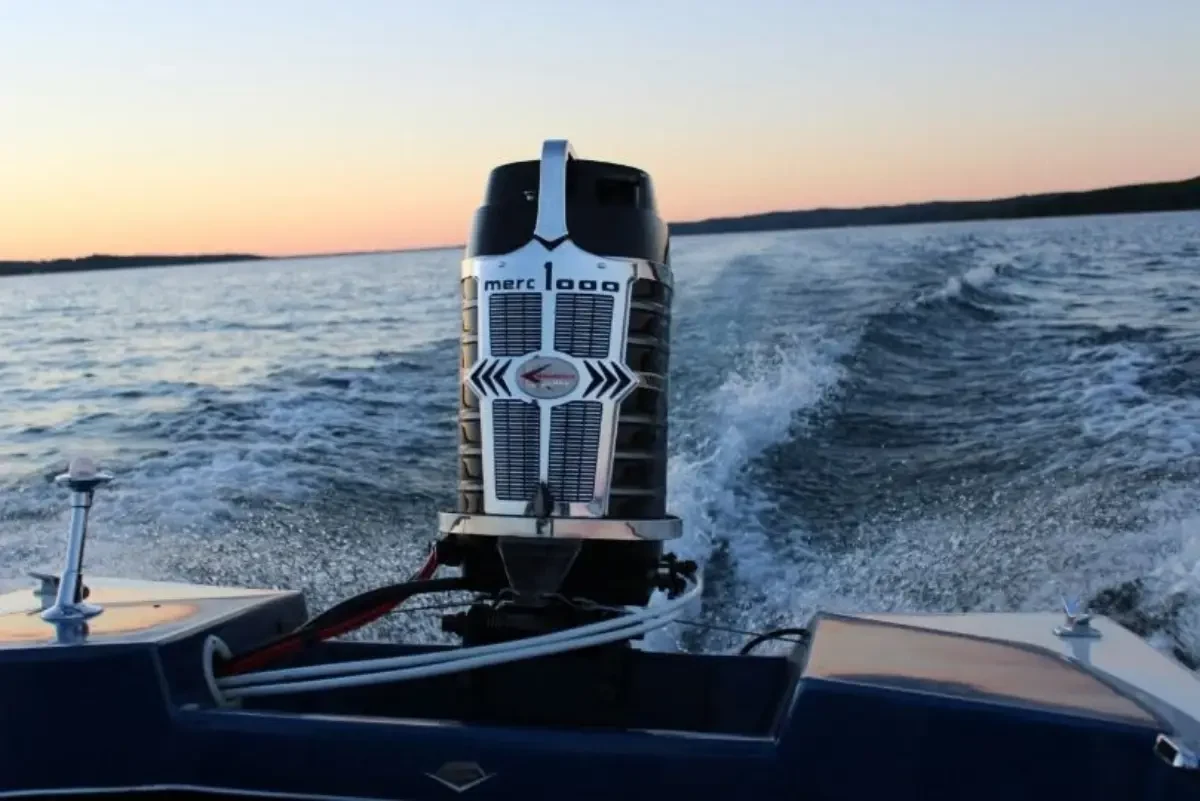 A preserved Mercury 1000 Tower of Power outboard motor running at sunset