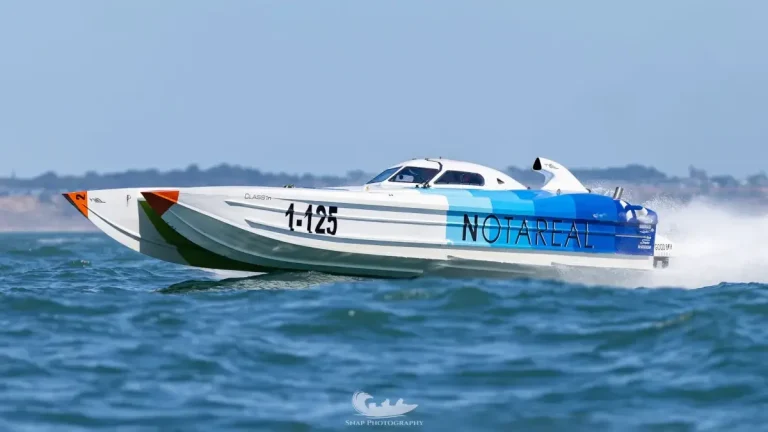 Notareal, the 1-125 Cougar catamaran raced by Joe Spoloric and Cade Wilson, at speed ahead of Cowes-Torquay-Cowes 2026