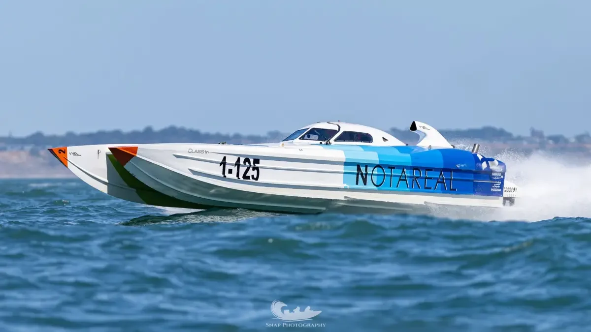Notareal, the 1-125 Cougar catamaran raced by Joe Spoloric and Cade Wilson, at speed ahead of Cowes-Torquay-Cowes 2026