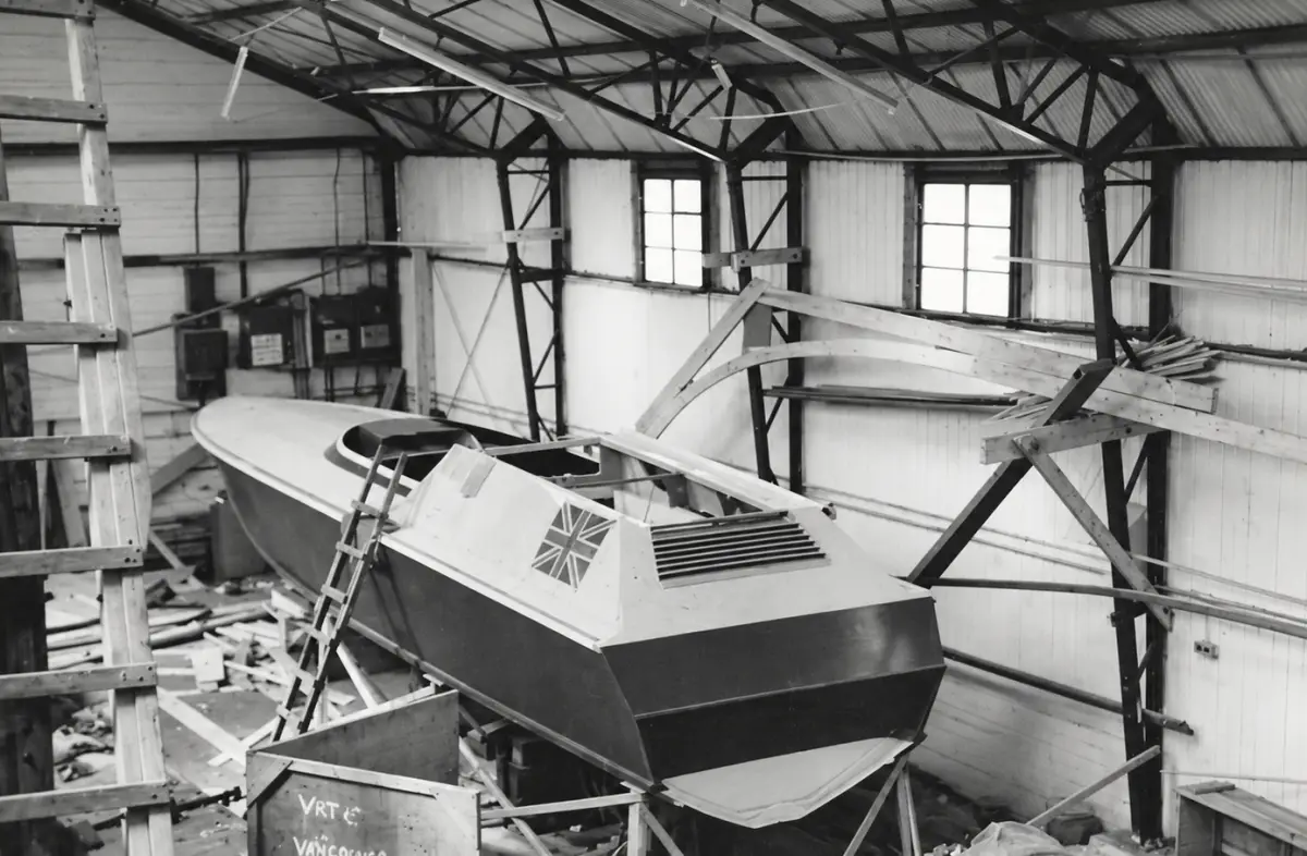 An Avenger hull under construction in a boat shed