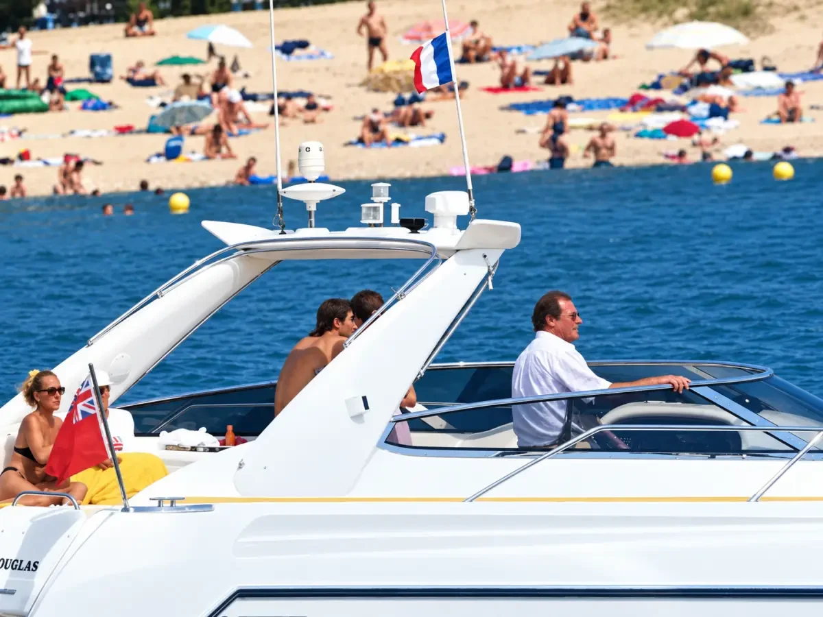 Roger Moore at the helm of his 1995 Sunseeker Tomahawk 41, a Don Shead design