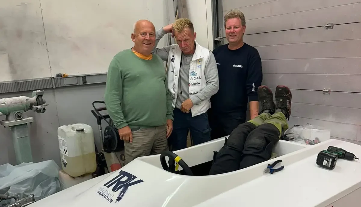 Tvedestrand Racing Klubb members with a GT10 boat and new engine parts in the workshop