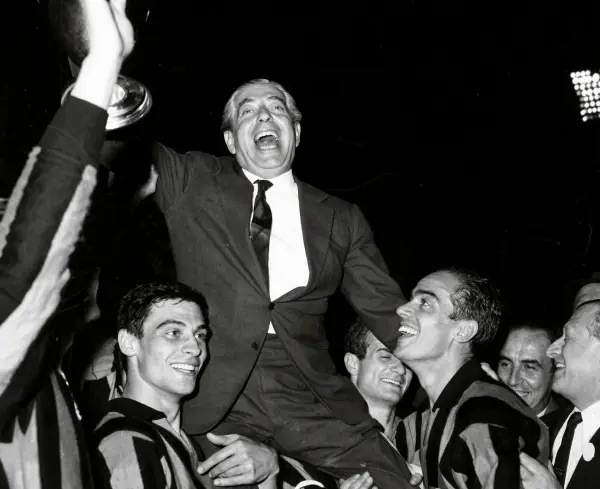 Angelo Moratti, black and white photograph, being carried shoulder high by Inter Milan players celebrating with a trophy