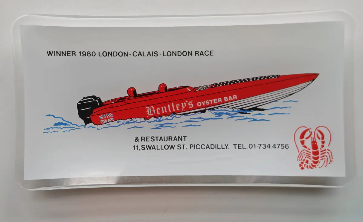 Glass souvenir dish showing the red Bentley's Oyster Bar race boat, winner of the 1980 London-Calais-London race