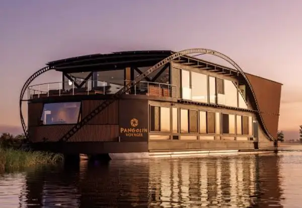 Pangolin Voyager solar-powered houseboat on the Chobe River at dusk