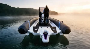 Rigid inflatable boat on calm water at dawn, powered by a RAD 40 electric outboard