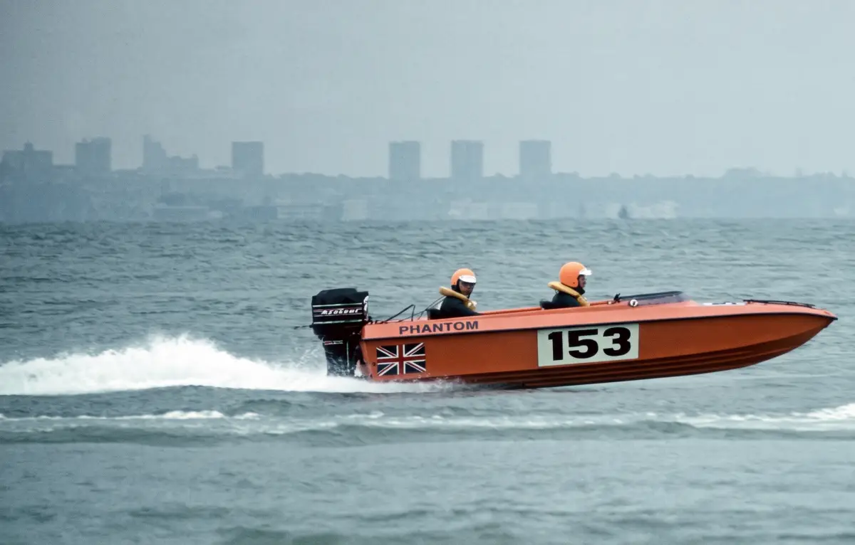 Phantom 16 race boat number 153 running at speed with two crew aboard