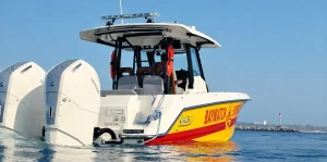 Boston Whaler in yellow and red Baywatch livery with twin Mercury outboards, from Fox's Baywatch trailer