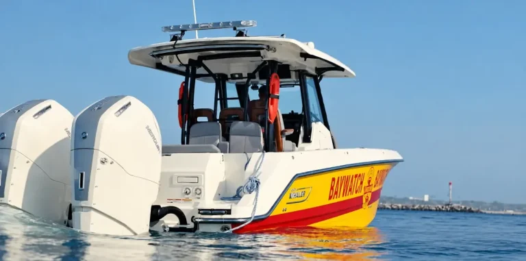 Boston Whaler in yellow and red Baywatch livery with twin Mercury outboards, from Fox's Baywatch trailer