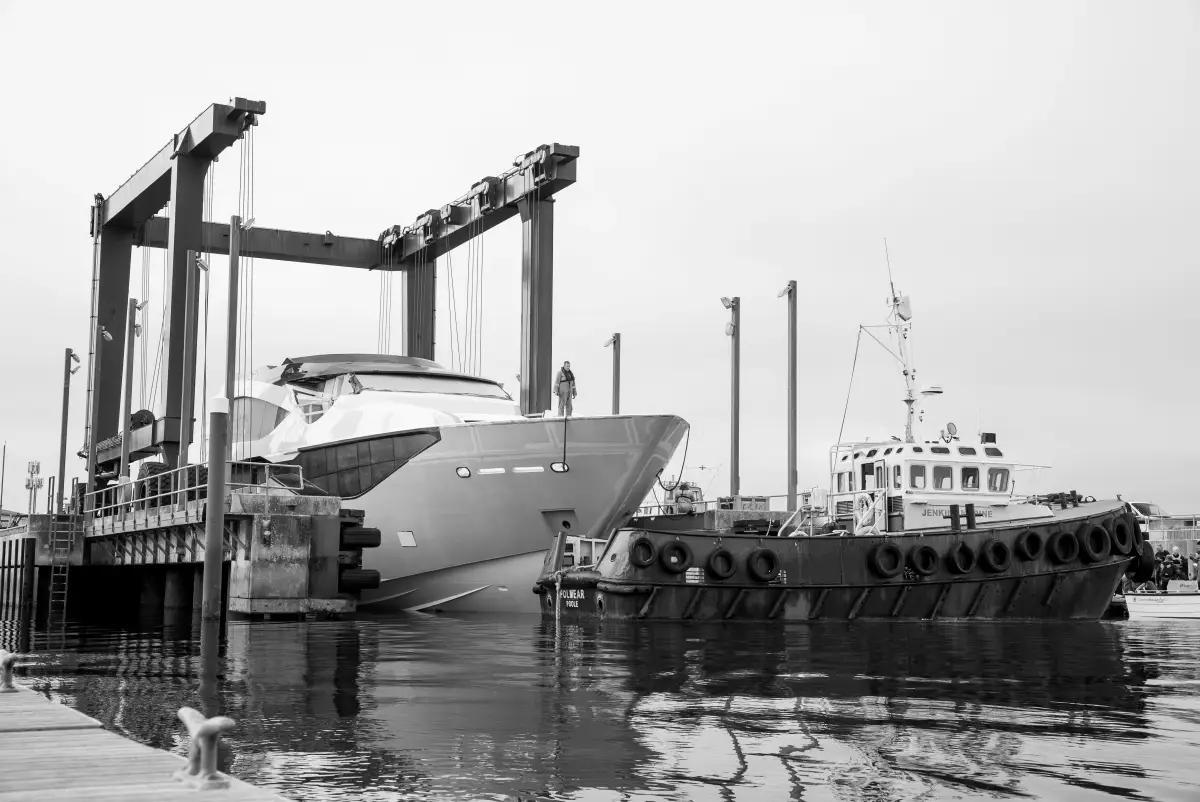Sunseeker 134 Superyacht alongside the travel hoist at Poole with the tug Polwear