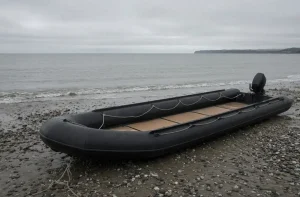 AI-generated illustration of a black inflatable boat with an outboard engine on a shingle beach under an overcast sky