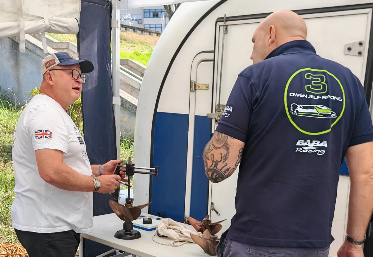 Dave Harwood checking a five-bladed DMLS propeller on a measuring stand in the pits, with Rob Bowyer of Owen Jelf Racing beside him
