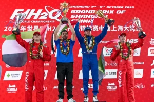 Alec Weckström lifts the winner's trophy on the Grand Prix of Shanghai podium alongside Stefan Arand and Grant Trask