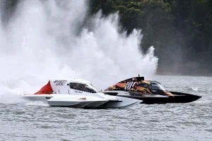 Dan Krusic in the GP21 Unlimited Hydroplane racing alongside GP101 at Lake Glenmaggie in 2025, with a wall of spray behind