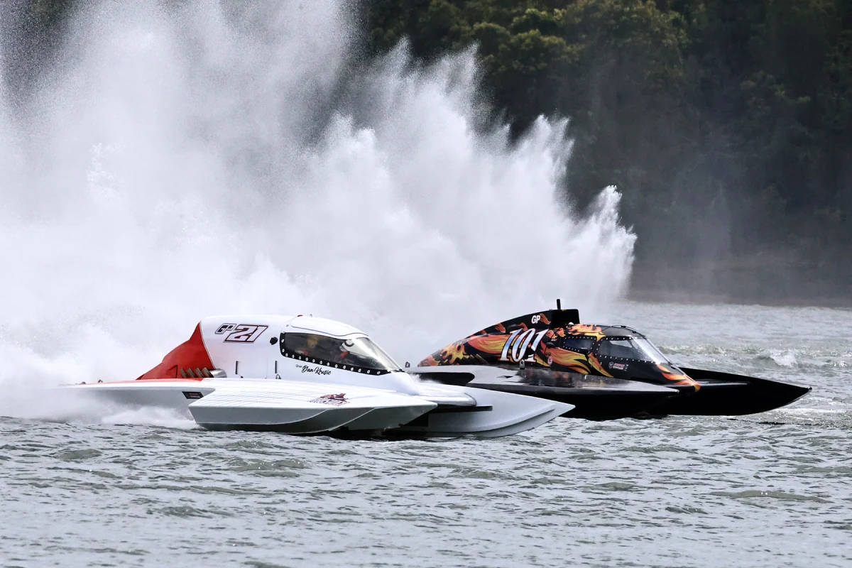 Dan Krusic in the GP21 Unlimited Hydroplane racing alongside GP101 at Lake Glenmaggie in 2025, with a wall of spray behind