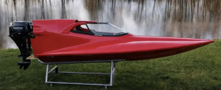 Red GT15 hull with a Tohatsu outboard fitted with an aeroscreen-type polycarbonate screen around the cockpit