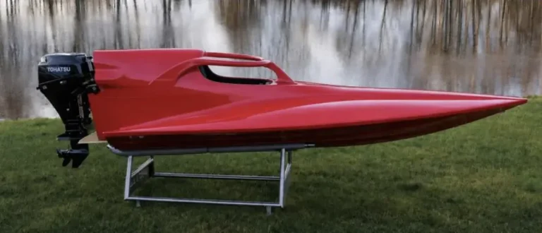Red GT15 hull with a Tohatsu outboard fitted with halo-type head protection over the cockpit