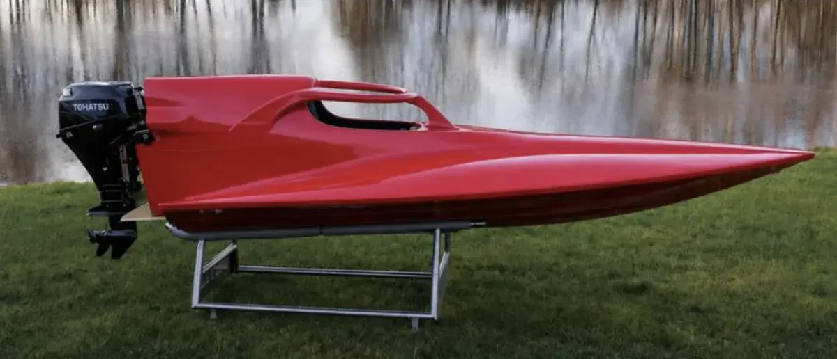 Red GT15 hull with a Tohatsu outboard fitted with halo-type head protection over the cockpit